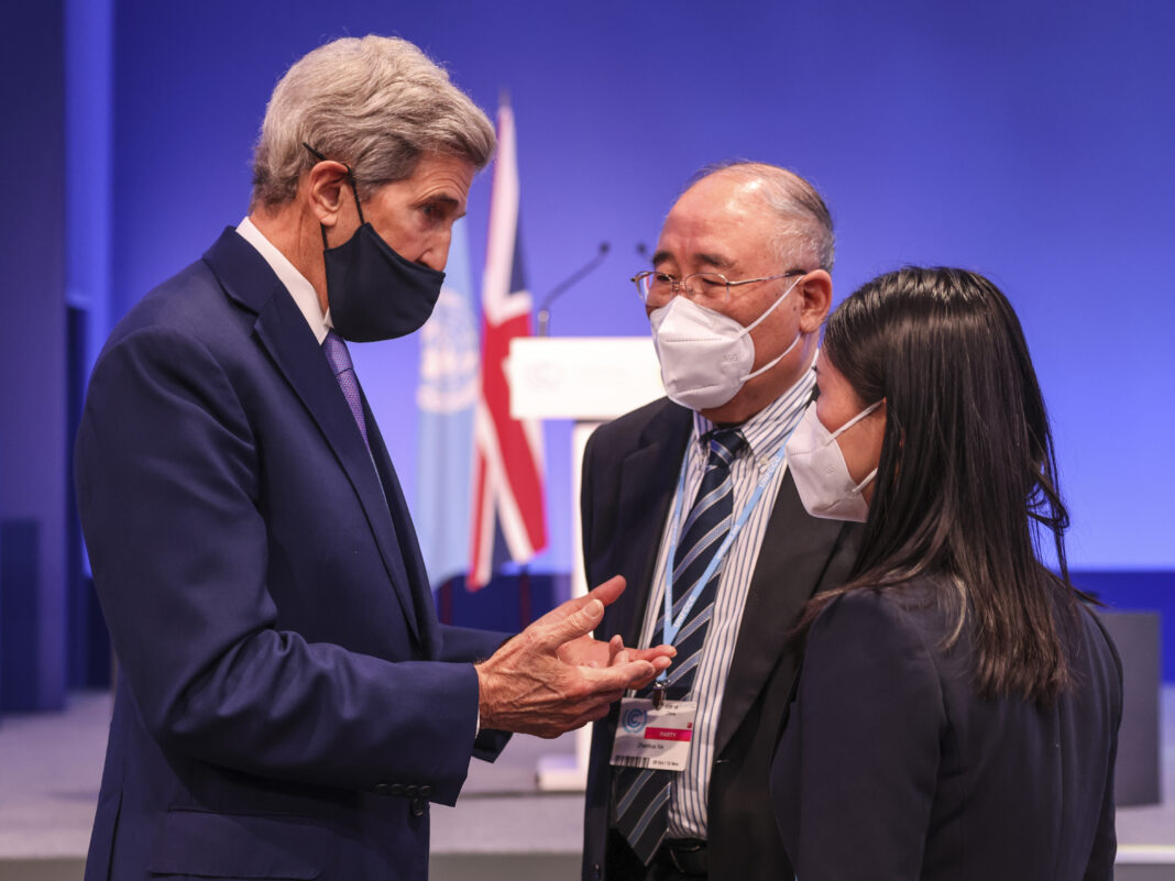 The U.S. Special Presidential Envoy for Climate, John Kerry talks to the Chinese special climate envoy Xie Zhenhua in an informal brush by at COP26